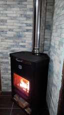 Стальной недорогой камин Теплодар ОВ-120 (угловой) фото в интерьере в Пинске
